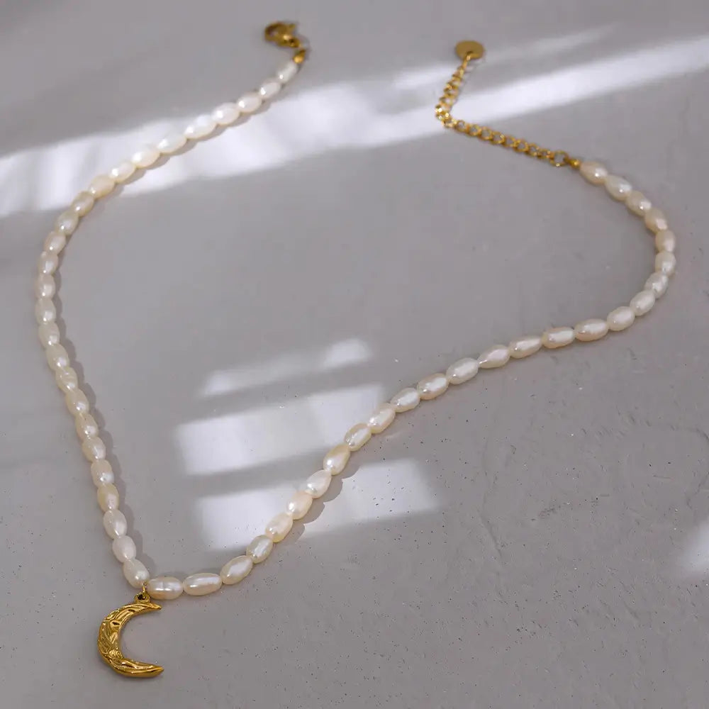 Colar Feminino de pérolas naturais com pingente meia lua dourada Celine, textura delicada e brilho suave em fundo claro