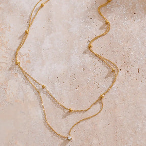 Colar Feminino Dourado duplo ponto de luz com zircônia, charme discreto em ambiente claro e elegante