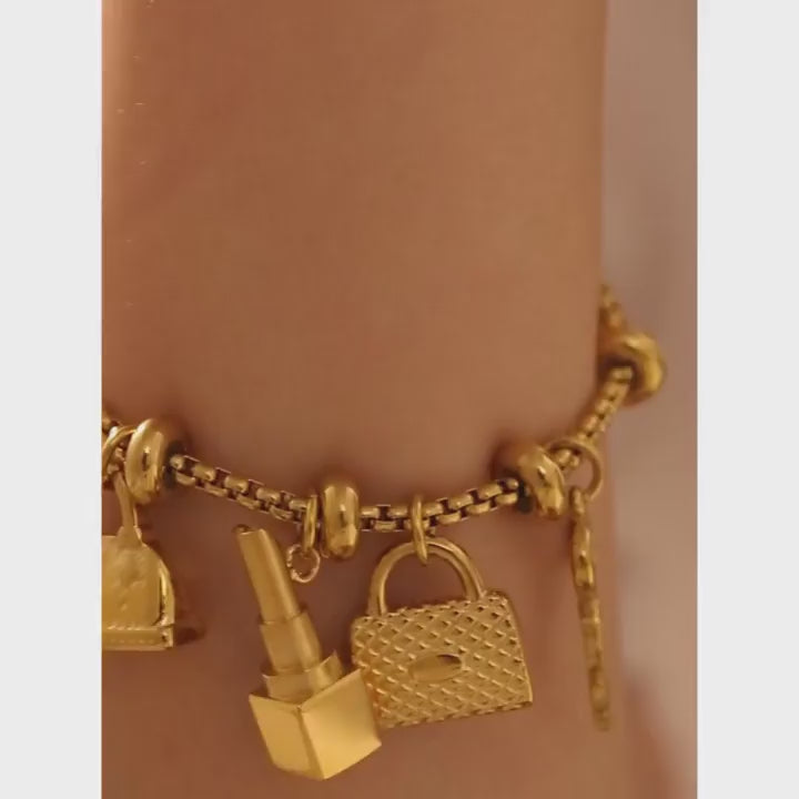 Pulseira Berloques em Aço Inox Dourada Feminina de Cadeado, Bolsa, Batom e Chave Luxelle - Banhada a Ouro 18k, vídeo demonstrativo